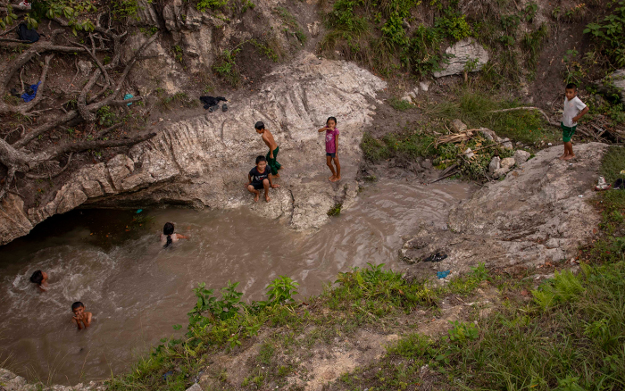 近くを流れるサンタローザ川で遊ぶ子どもたち。川の水は汚染され、飲料用には適していない。