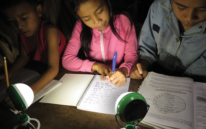 Girl Doing Homework with Nokero Solar Powered Lamp